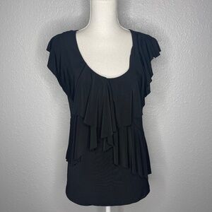 Black tank top with ruffles details .